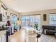 Living space with hardwood floors, kitchen island, desk area, and sliding glass doors to a patio at 1441 Central # 305, Denver, CO 80211