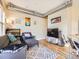 Comfortable living area with hardwood floors, stylish decor, and a TV, offering a relaxing space at 1441 Central # 305, Denver, CO 80211