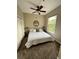 Bright bedroom with a large window, ceiling fan, and comfortable king-sized bed at 1441 Central # 305, Denver, CO 80211