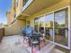 Outdoor patio with a dining table and chairs set upon a vibrant striped rug and peaceful hammock at 1441 Central # 305, Denver, CO 80211