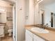 Bathroom with single vanity and well-lit mirror, and adjacent toilet and shower room at 8717 Carr Loop, Arvada, CO 80005