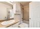 Bright bathroom with neutral-tone tile and shower-tub combination at 8717 Carr Loop, Arvada, CO 80005