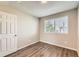 Well-lit bedroom featuring hardwood floors and a bright window at 8717 Carr Loop, Arvada, CO 80005