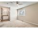 Bright bedroom featuring a ceiling fan and neutral carpet, with an ensuite bathroom at 8717 Carr Loop, Arvada, CO 80005