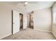 Bright bedroom featuring a ceiling fan and neutral carpet, with views to the ensuite bathroom at 8717 Carr Loop, Arvada, CO 80005