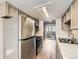 Kitchen features stainless steel appliances, white marble counter tops, and light wood floor at 8717 Carr Loop, Arvada, CO 80005