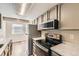 Modern kitchen with stainless steel appliances and ample cabinet space at 8717 Carr Loop, Arvada, CO 80005