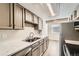 Bright kitchen features stainless steel appliances, a double sink, and white counter tops at 8717 Carr Loop, Arvada, CO 80005