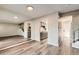 Open concept living room with staircase, wood floors, and access to the kitchen at 8717 Carr Loop, Arvada, CO 80005
