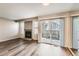 Spacious living room featuring a fireplace, wood floors, and a sliding glass door at 8717 Carr Loop, Arvada, CO 80005