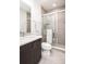 Modern bathroom with glass shower, white vanity, and chrome hardware at 43 S Oneida Ct, Denver, CO 80230