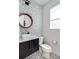 Stylish powder room featuring a mosaic accent wall, modern vanity, and sleek fixtures at 43 S Oneida Ct, Denver, CO 80230