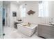 Bright bathroom with a soaking tub, modern vanity, and stylish decor at 43 S Oneida Ct, Denver, CO 80230