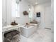 Bright bathroom with a soaking tub, modern vanity, and ample natural light at 43 S Oneida Ct, Denver, CO 80230
