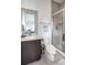 Modern bathroom featuring a glass-enclosed shower, sleek vanity, and contemporary fixtures at 43 S Oneida Ct, Denver, CO 80230