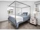 Bright bedroom features a modern four-poster bed, plush carpet, and natural light from a window at 43 S Oneida Ct, Denver, CO 80230