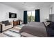 Spacious bedroom features balcony access, a plush rug, and ample seating at 43 S Oneida Ct, Denver, CO 80230