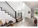 Bright, open entryway showcasing modern staircase, hardwood floors, and seamless transition to living spaces at 43 S Oneida Ct, Denver, CO 80230