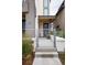 Inviting front porch with a secure gate, stylish blue door, and well-maintained walkway at 43 S Oneida Ct, Denver, CO 80230