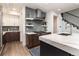 Gourmet kitchen with stainless steel range hood, backsplash and custom cabinets at 43 S Oneida Ct, Denver, CO 80230