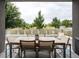Relaxing outdoor patio with dining table and chairs, offering beautiful views of the community landscape at 43 S Oneida Ct, Denver, CO 80230