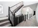 Elegant staircase with modern railing, complemented by stylish decor and ample natural light at 43 S Oneida Ct, Denver, CO 80230