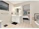 Bathroom with a double vanity and view into the bedroom at 10993 Ledges Rd, Parker, CO 80134
