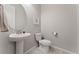 Simple powder room with pedestal sink and gray tile flooring at 10993 Ledges Rd, Parker, CO 80134