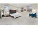 Bright bedroom with a king-size bed and teal accent chair at 10993 Ledges Rd, Parker, CO 80134