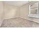 Empty bedroom with a window and built-in shelving at 10993 Ledges Rd, Parker, CO 80134