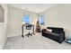 Bedroom with desk, chair, and sofa against a neutral backdrop, creating a versatile space at 10993 Ledges Rd, Parker, CO 80134
