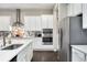Modern kitchen with white cabinets, stainless steel appliances, and quartz countertops at 10993 Ledges Rd, Parker, CO 80134