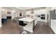 Modern kitchen with white cabinets, a large island, and stainless steel appliances at 10993 Ledges Rd, Parker, CO 80134