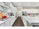 Bright white kitchen with gas cooktop, custom backsplash, and ample cabinetry at 10993 Ledges Rd, Parker, CO 80134