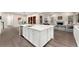 Modern white kitchen island with quartz countertops and stainless steel appliances at 10993 Ledges Rd, Parker, CO 80134