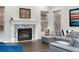 Comfortable living room featuring a fireplace with decorative tile surround and ample natural light at 10993 Ledges Rd, Parker, CO 80134