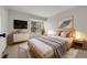 Well-lit bedroom with large window, art, and stylish modern furniture at 1818 S Quebec Way # 3-4, Denver, CO 80231