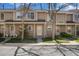 Charming townhouse showcasing a well-maintained front yard and covered entrance at 1818 S Quebec Way # 3-4, Denver, CO 80231