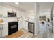 Modern kitchen featuring white cabinetry, stainless steel appliances, and stylish backsplash at 1818 S Quebec Way # 3-4, Denver, CO 80231