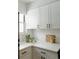 White kitchen cabinets, quartz countertops, and black hardware at 1818 S Quebec Way # 3-4, Denver, CO 80231