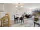 Open-concept living room with a dining area and sliding glass doors to the balcony at 1818 S Quebec Way # 3-4, Denver, CO 80231