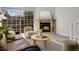 Cozy living room boasting a brick fireplace and sliding glass doors to the balcony at 1818 S Quebec Way # 3-4, Denver, CO 80231