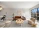 Spacious living room with stylish decor, a leather sofa, and a modern rug at 1818 S Quebec Way # 3-4, Denver, CO 80231