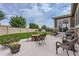 Outdoor patio with ample seating space for relaxing and entertaining, surrounded by a lush lawn and stone wall at 12578 Hudson Ct, Thornton, CO 80241