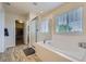 Bright bathroom featuring a soaking tub, glass shower, and tile flooring, offering a spa-like experience at 12578 Hudson Ct, Thornton, CO 80241