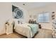Bright bedroom with a cozy bed, decorative wall art, and a window providing ample natural light at 12578 Hudson Ct, Thornton, CO 80241