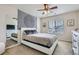 Cozy bedroom features a full bed with a tapestry wall hanging, mirrored closet, and a window for natural light at 12578 Hudson Ct, Thornton, CO 80241