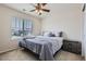 Comfortable bedroom featuring a full bed, nightstand, carpet, and a window with neighborhood views at 12578 Hudson Ct, Thornton, CO 80241