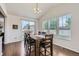 Cozy dining room with hardwood floors, natural light from large windows, and access to the backyard at 12578 Hudson Ct, Thornton, CO 80241