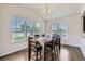 Bright dining room with hardwood floors and large windows offering a view of the fenced backyard at 12578 Hudson Ct, Thornton, CO 80241
